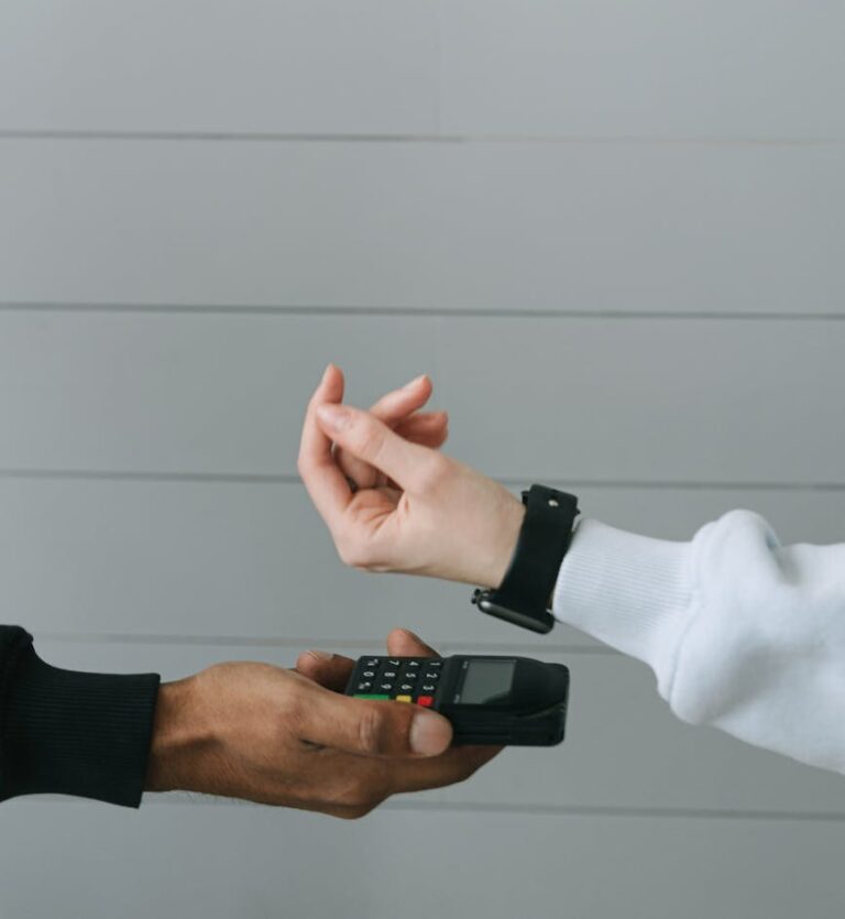 Close-up of a smartwatch being used for a contactless payment at a digital card terminal.
